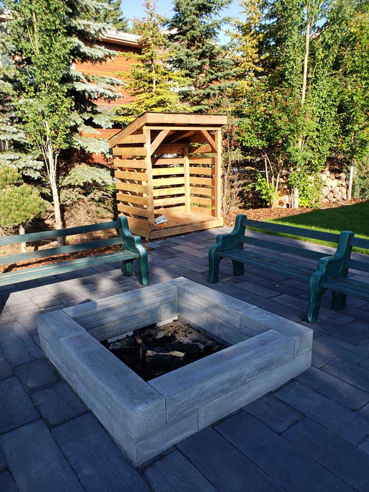 Gray composite deck with a custom firepit and benches