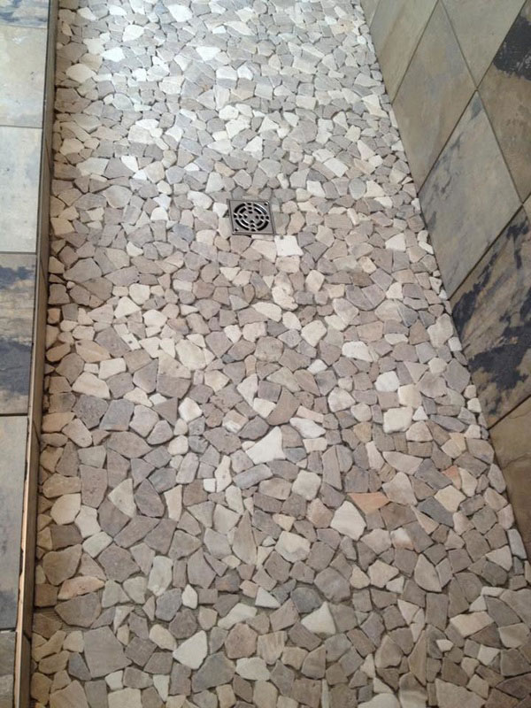 river rock tile creating shower floor