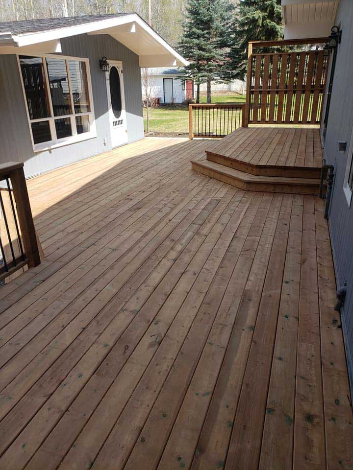 Cedar plank deck with steps up to entry to a home