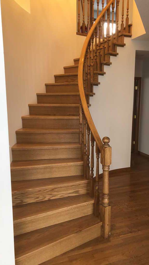 Curved staircase with oak stairs and bannister