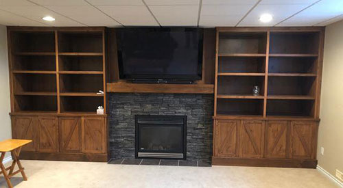 custom wood entertainment centre with fireplace and tv