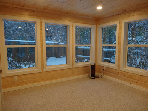Pine wood sunroom with multiple windows and Duradek flooring
