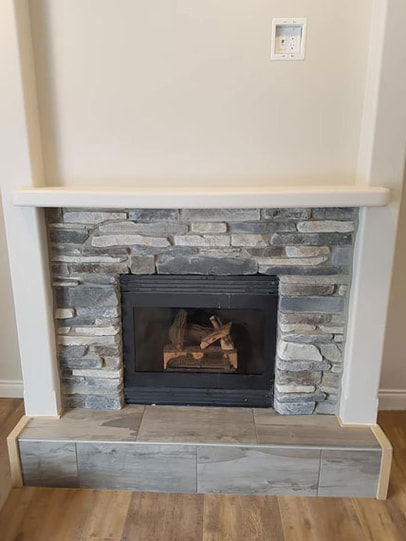 grey stone fireplace with gas insert
