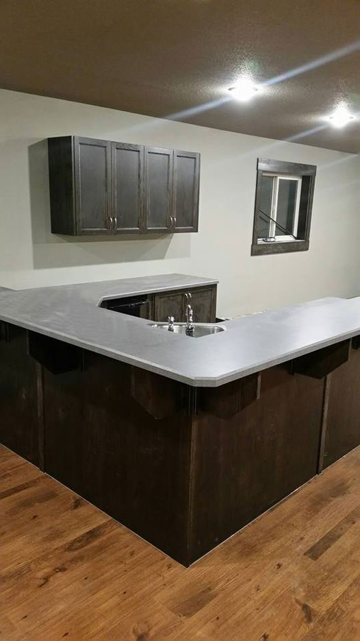 basement wet bar with u-shaped countertop and corner sink