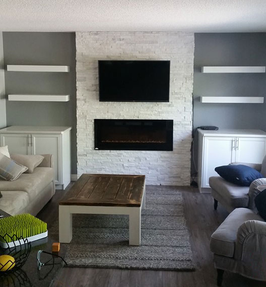 white stone fireplace with wall mounted fireplace and tv above