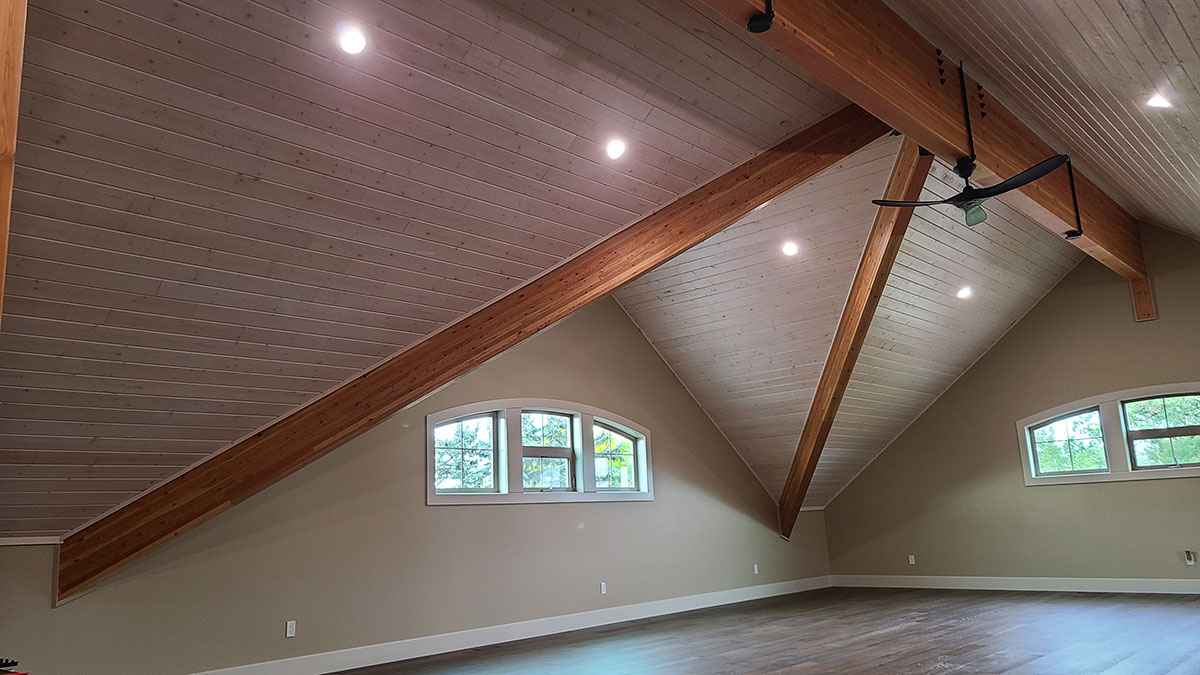 Bonus room with a pine ceiling and large exposed beams